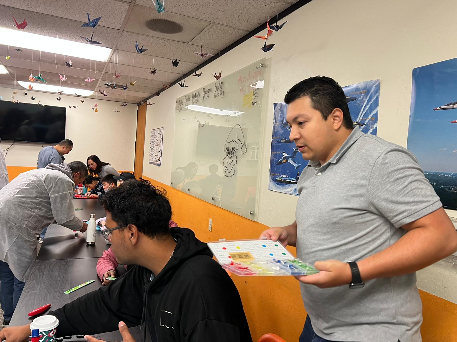 Kids and volunteers building electronics projects at a San Ramon youth workshop